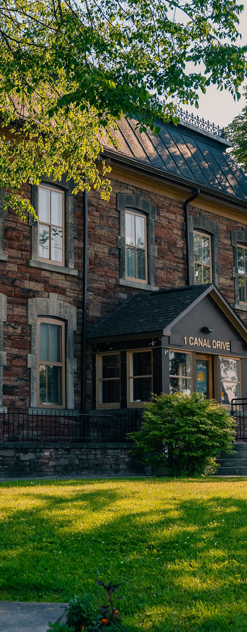 Historic stone building with lush greenery