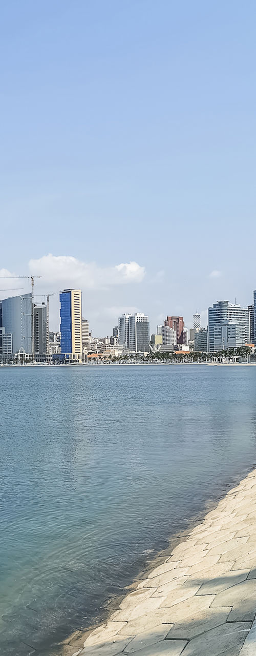 Coastal cityscape with palm trees and promenade
