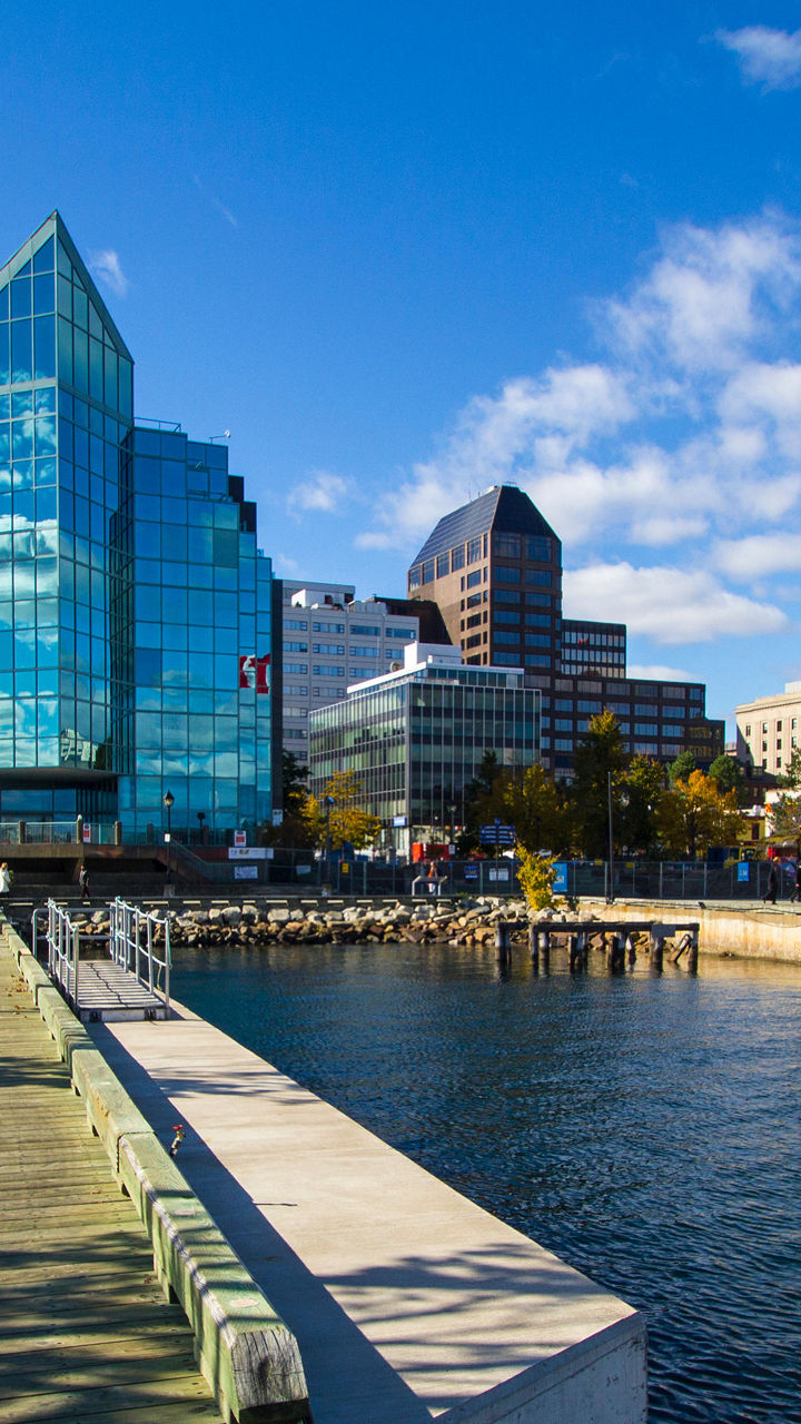 Scenic waterfront with Canadian flag and skyline