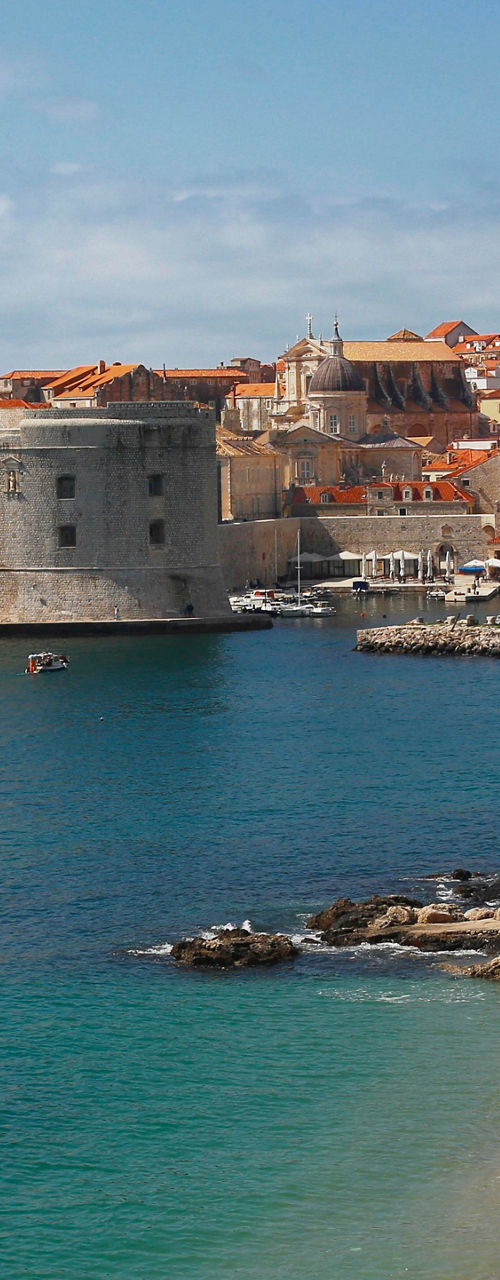 Historic coastal city with sandy beach
