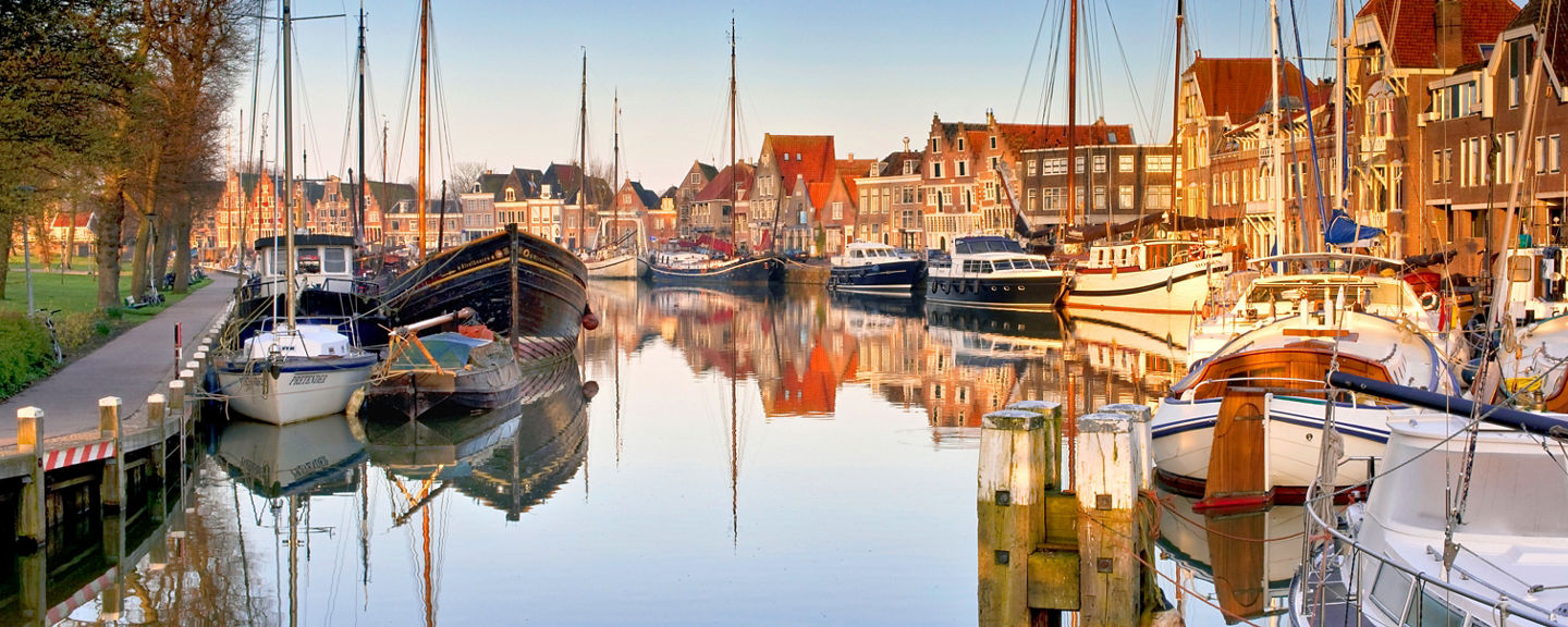 Scenic harbor with sailboats at sunrise
