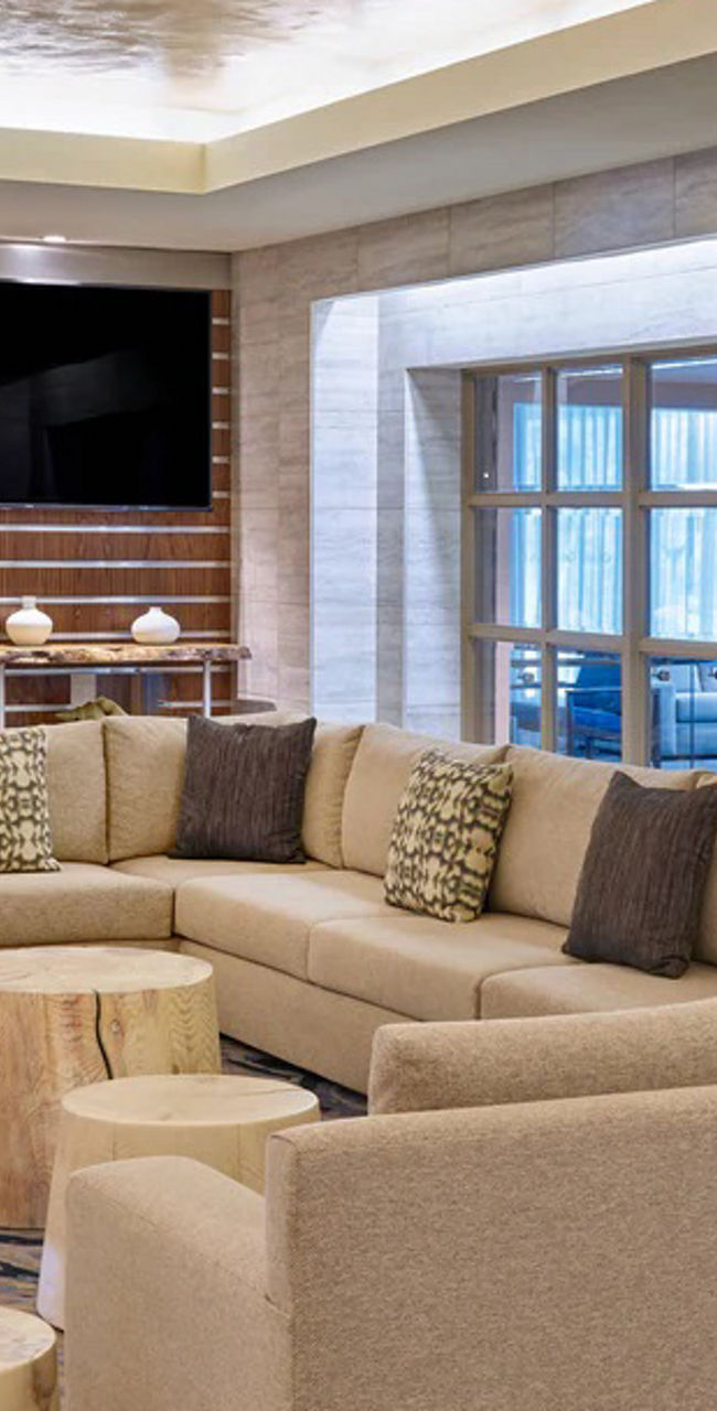 Modern lounge with green wall and seating