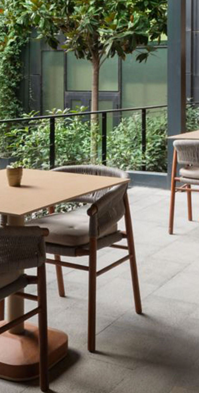 Modern outdoor dining area with greenery