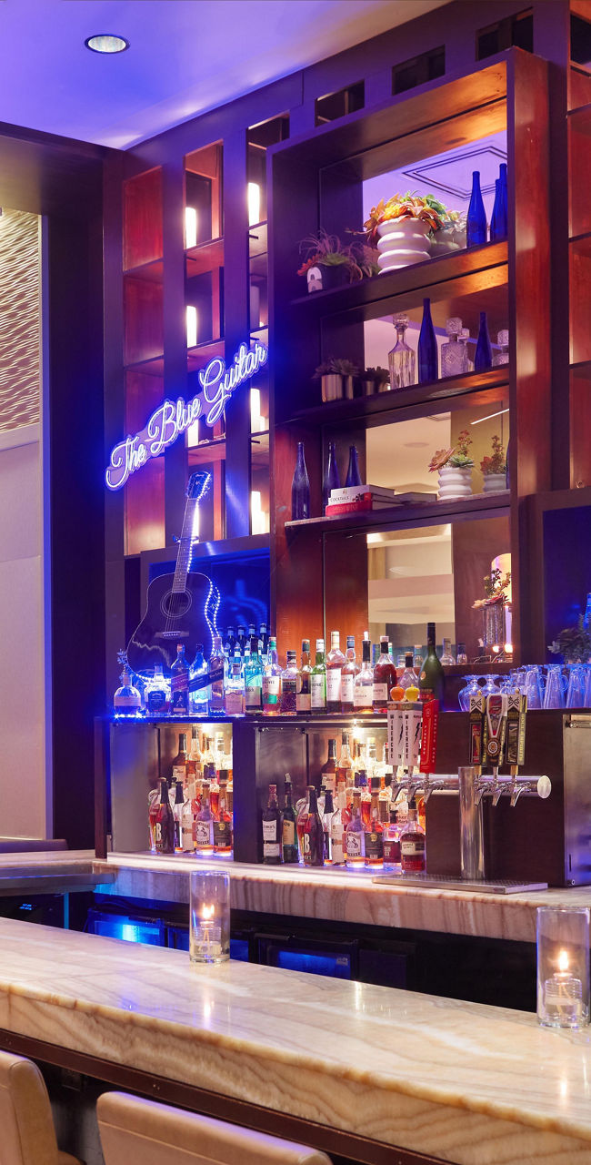 Modern hotel bar with seating and lighting