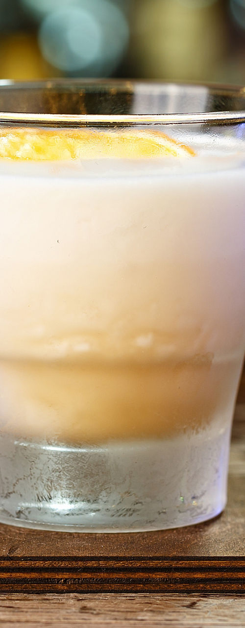 Creamy cocktail with orange garnish