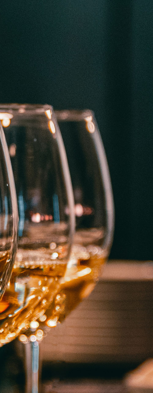 Pouring white wine into elegant glasses