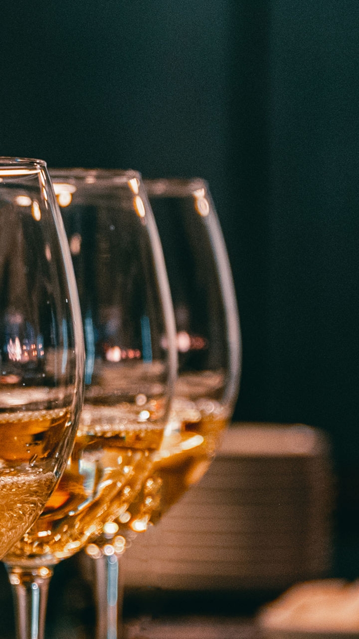 Pouring white wine into elegant glasses