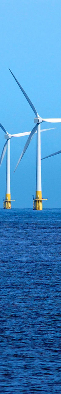 Offshore wind turbines in blue ocean