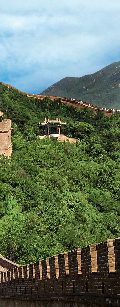Great Wall of China across green mountains