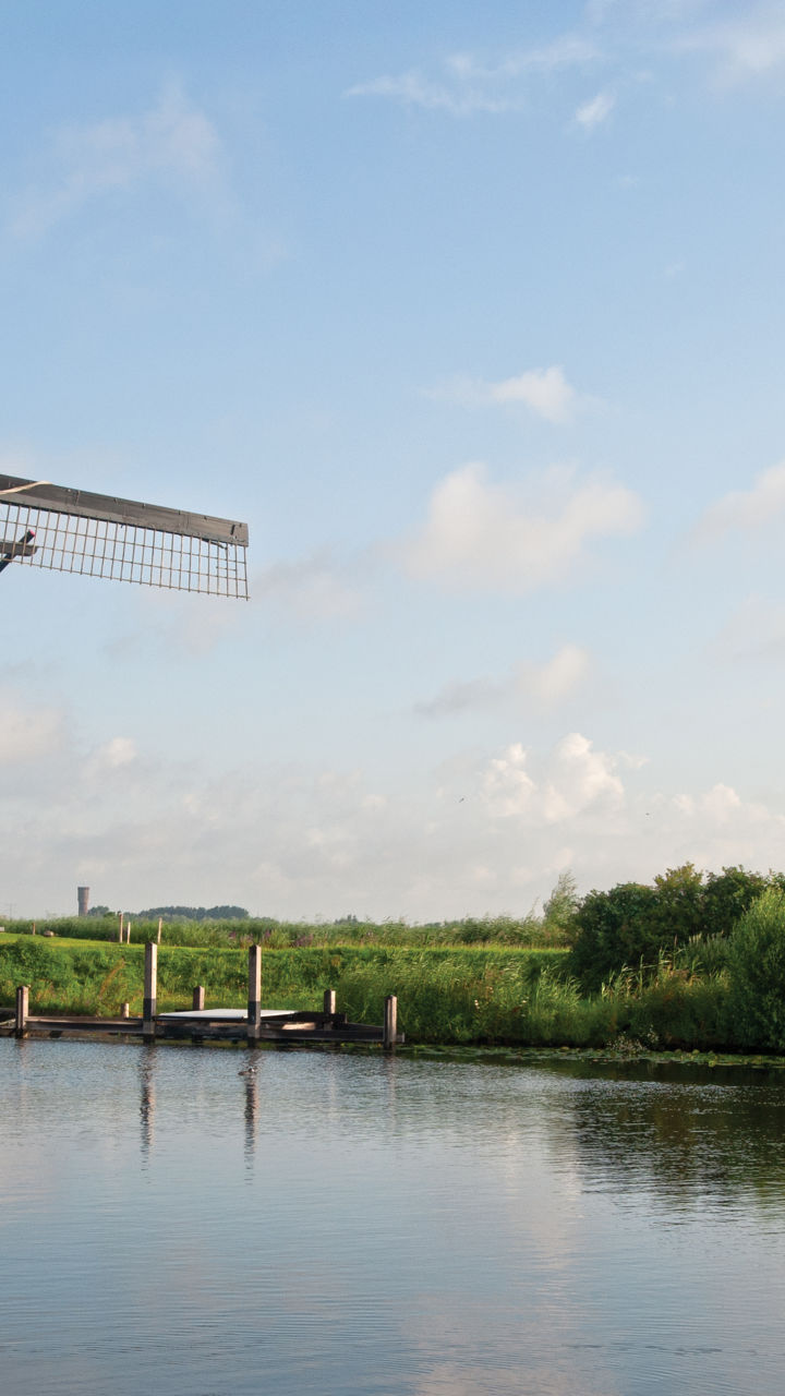 Traditional windmills by a serene canal