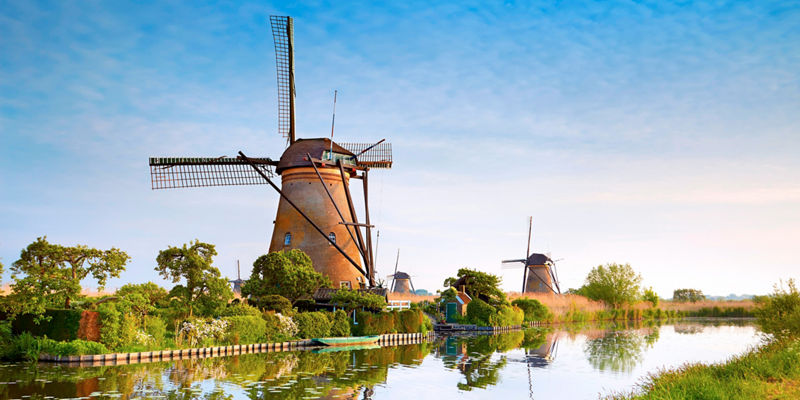 Historic windmills by a serene canal