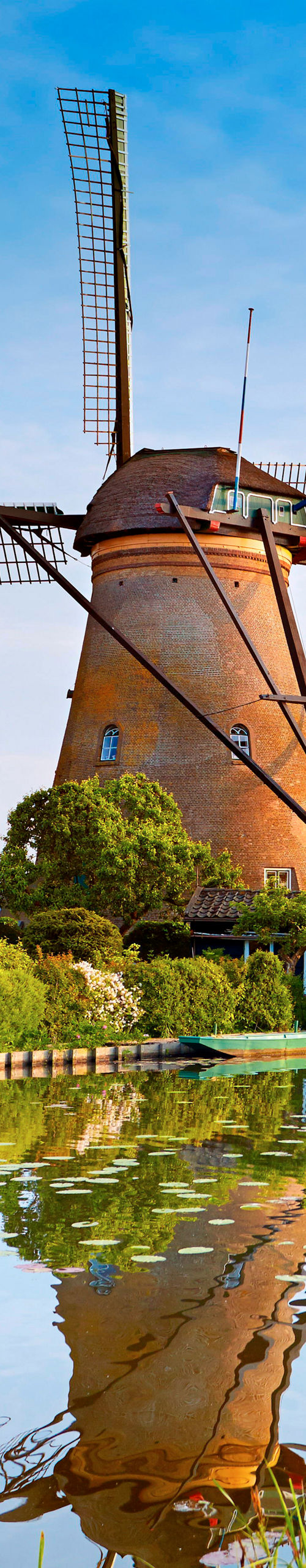 Historic windmills by a serene canal