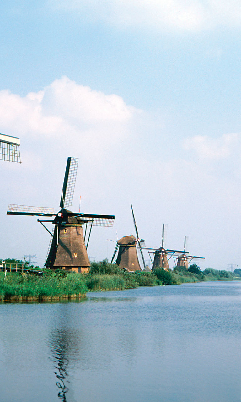 Historic windmills by a serene canal