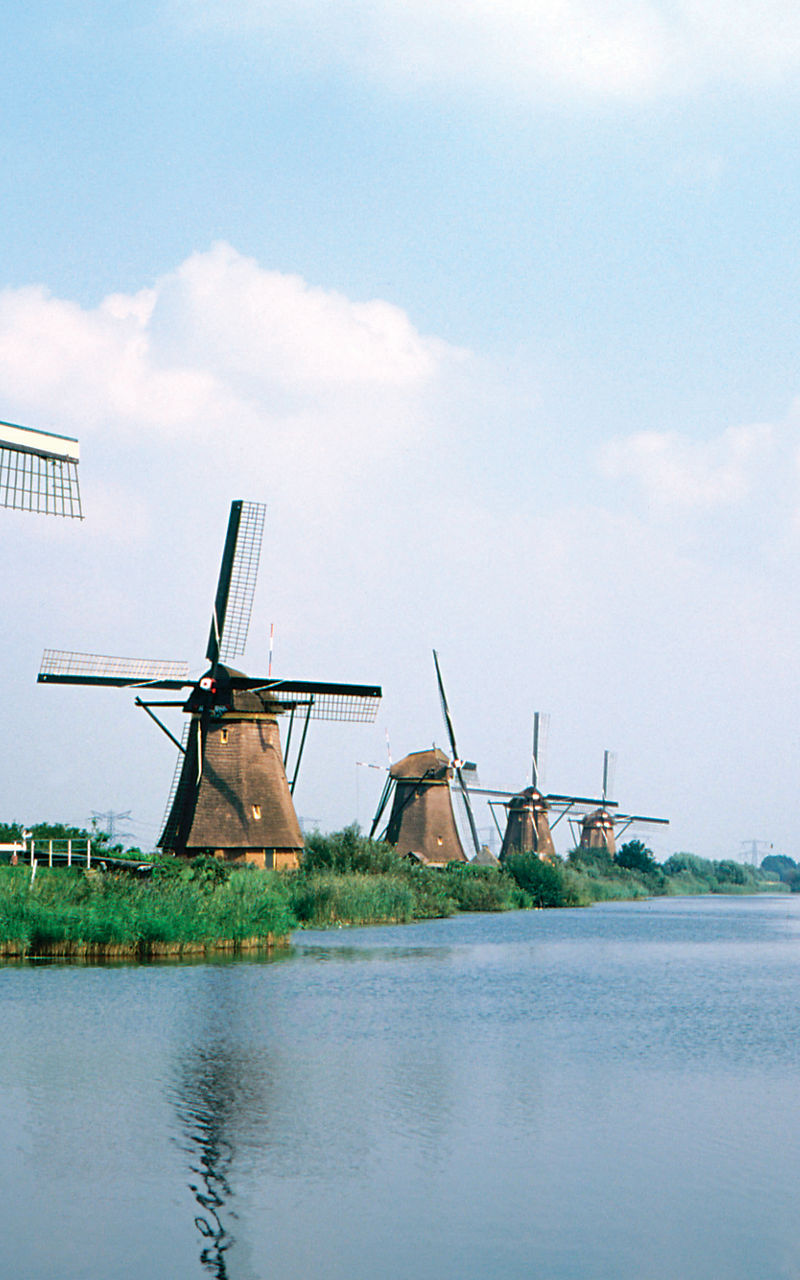 Historic windmills by a serene canal