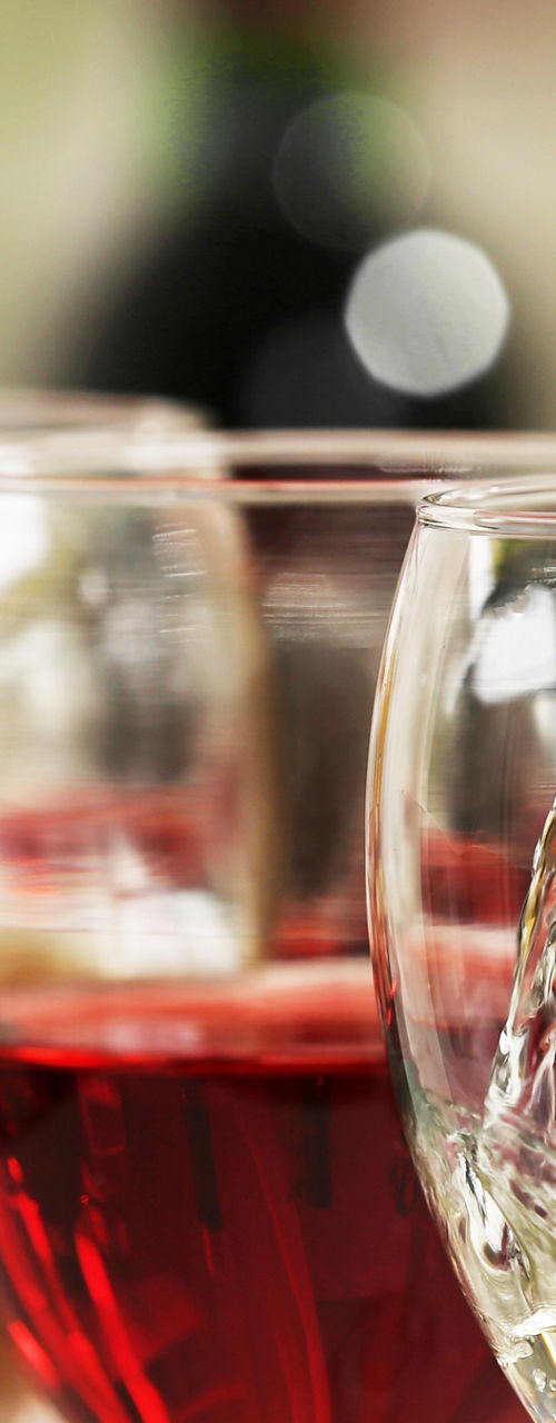 Pouring white wine into glass with others