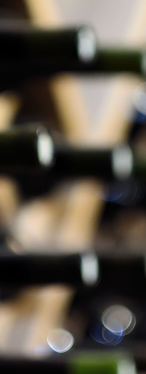 Wine bottles arranged on wooden racks