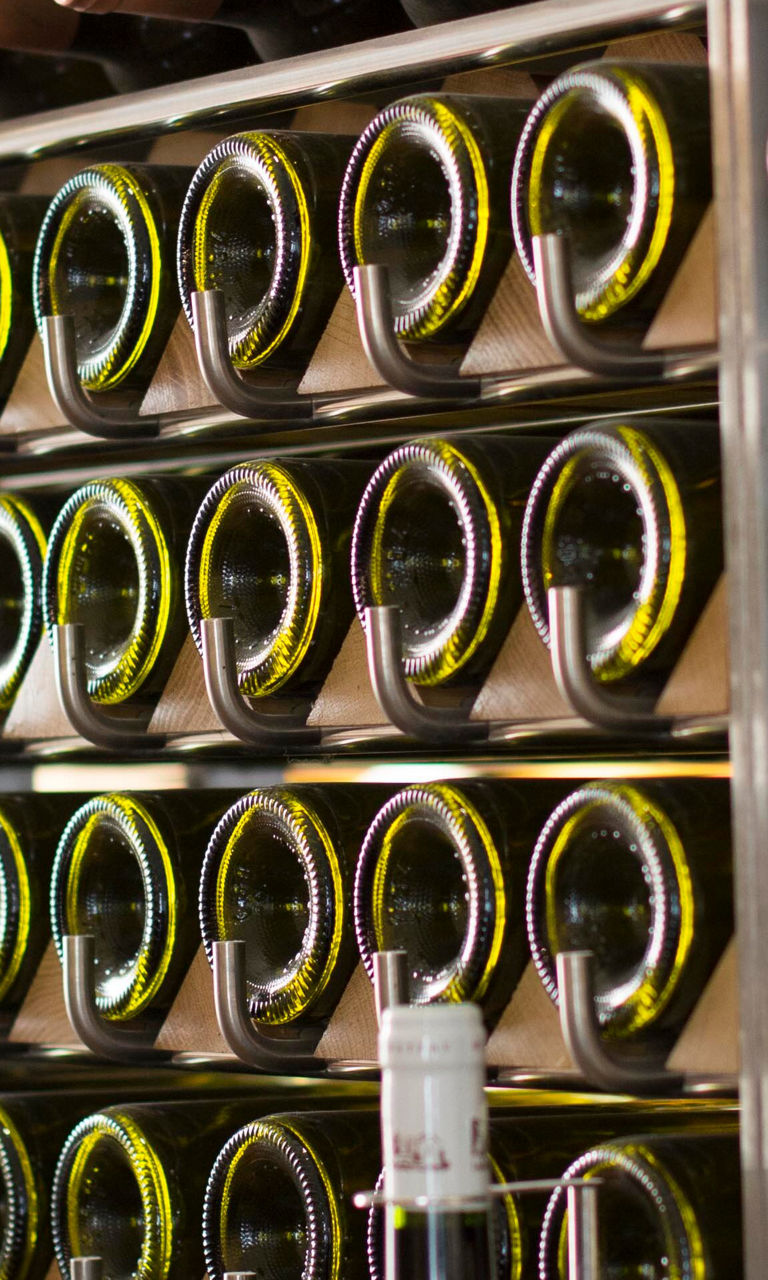 Wine bottles on modern storage rack