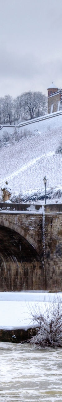 Snow-covered bridge and historic castle view