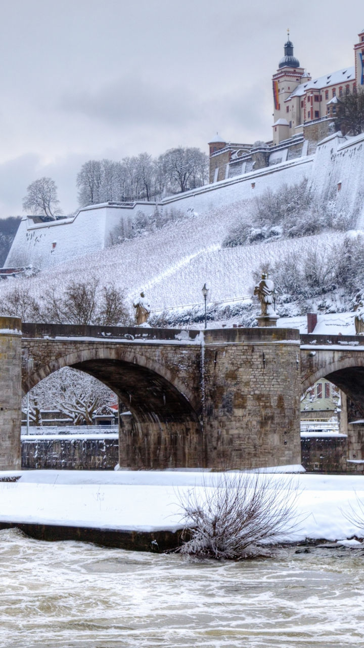 Snow-covered bridge and historic castle view