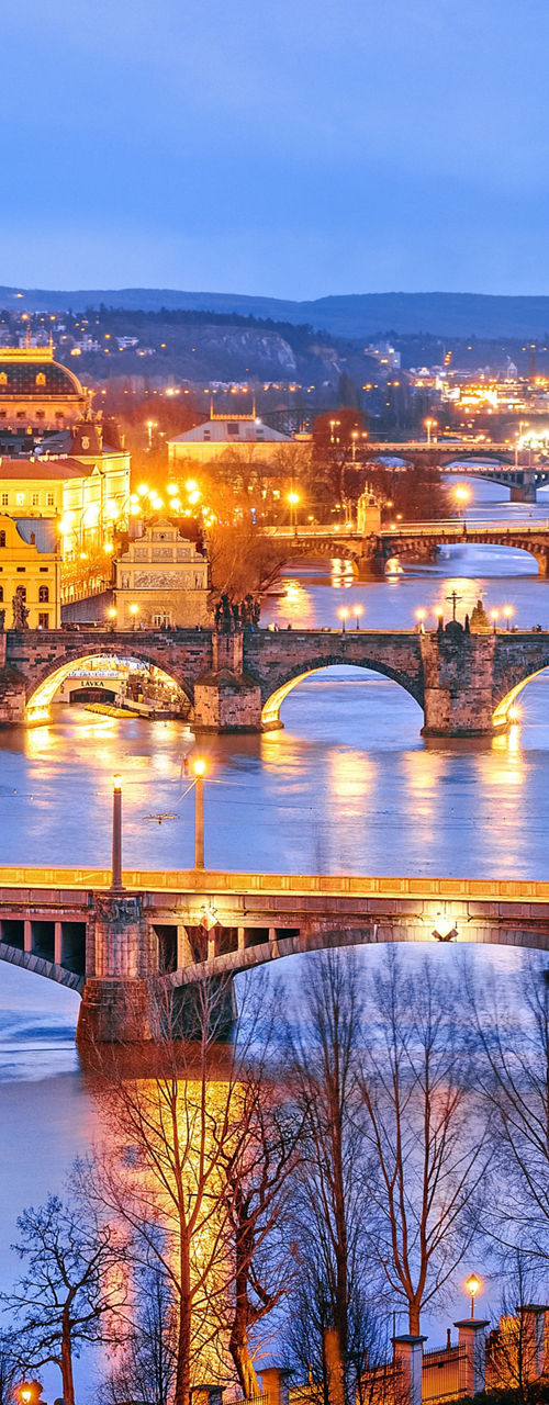Evening cityscape with illuminated bridges over river