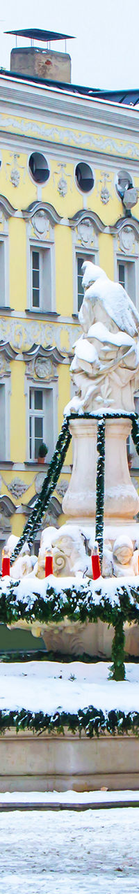 Snowy town square with festive fountain