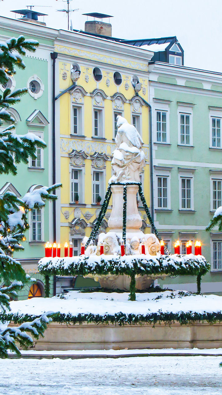 Snowy town square with festive fountain
