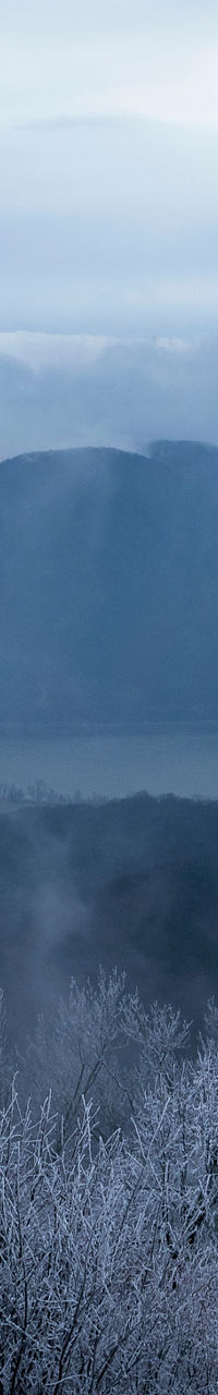 Winter river bend with misty mountains