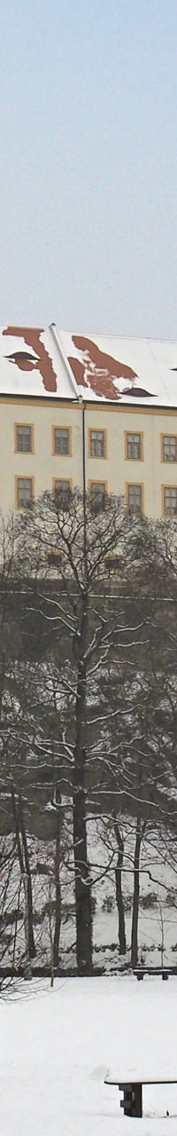 Historic hilltop monastery above snowy park