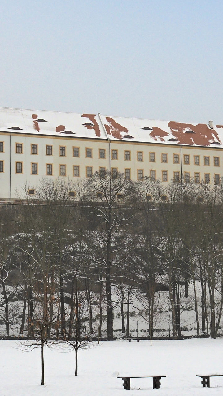 Historic hilltop monastery above snowy park