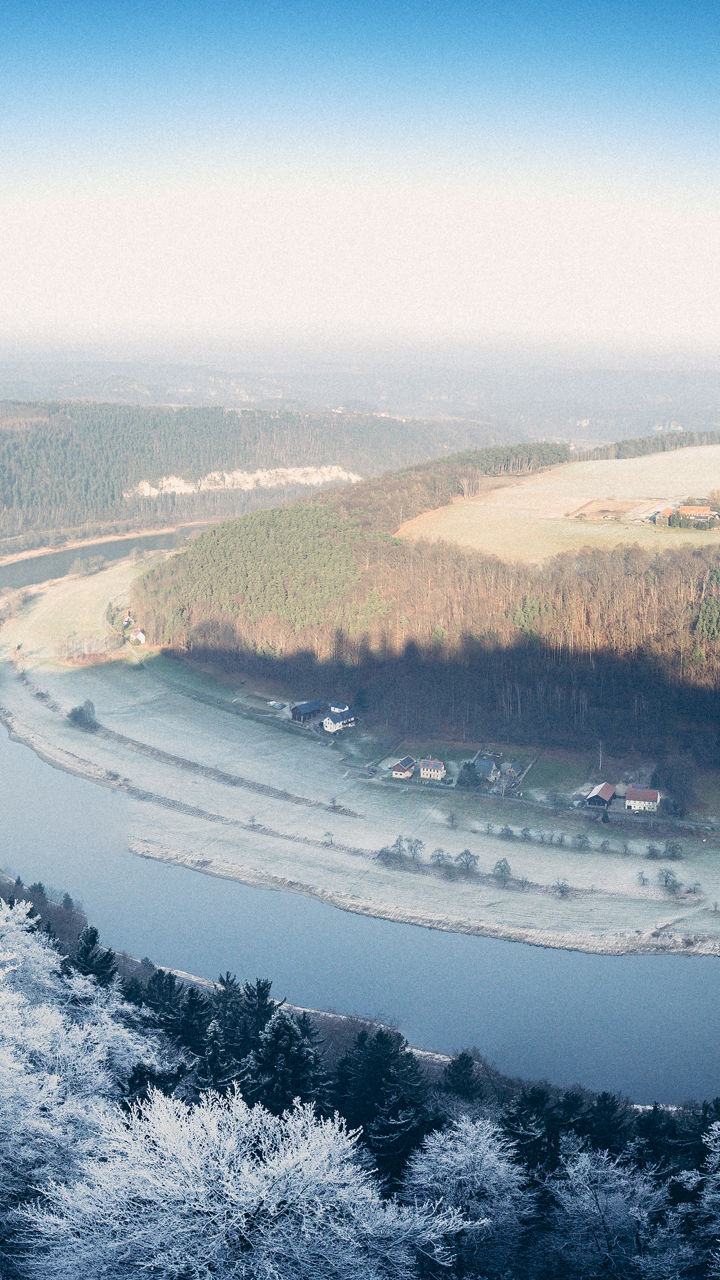 Winter river valley with snowy cliffs
