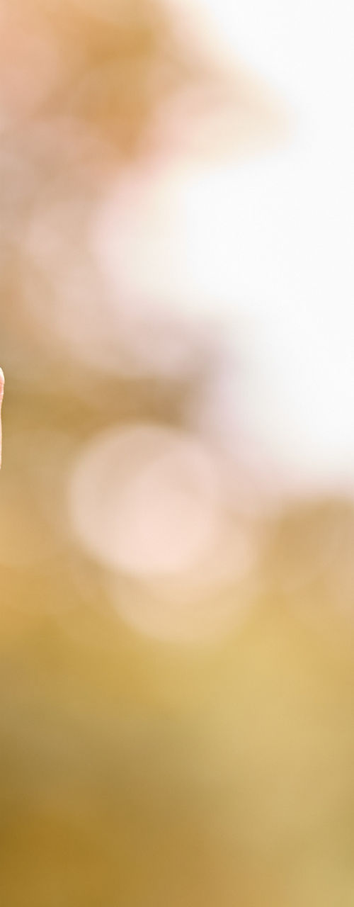 Close-up of hand holding a camera outdoors