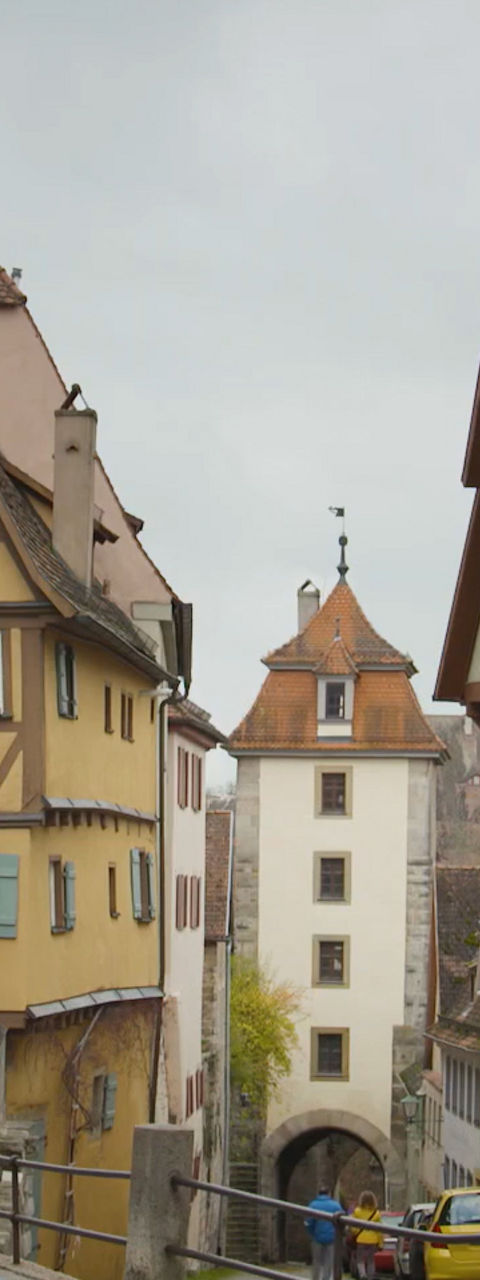Tourists photographing medieval street in historic town