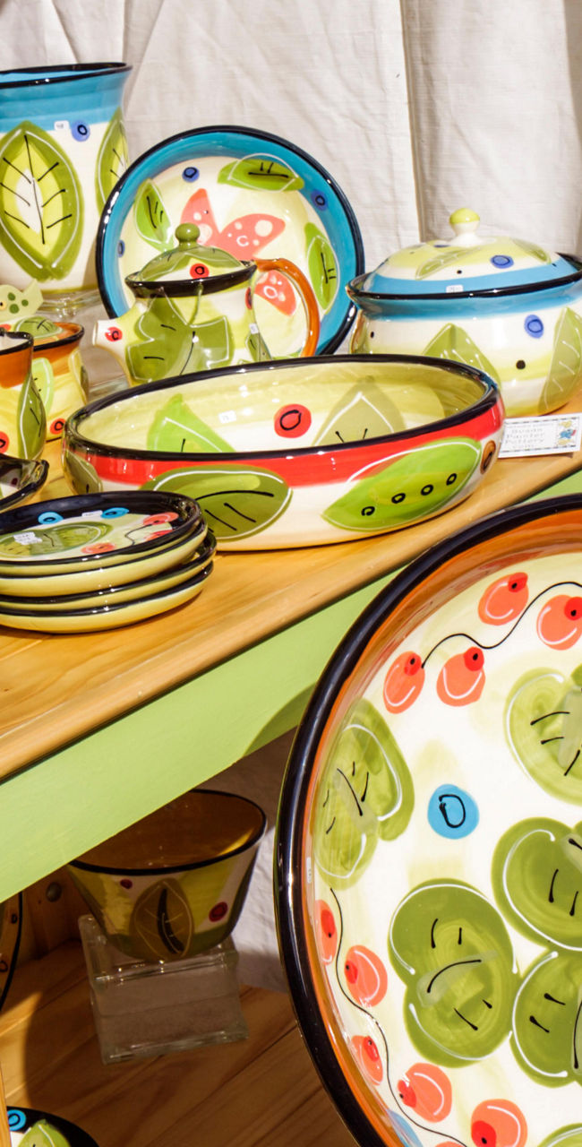 Hand-painted ceramic plates and bowls display