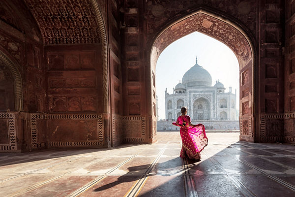 Woman in vibrant sari at Taj Mahal