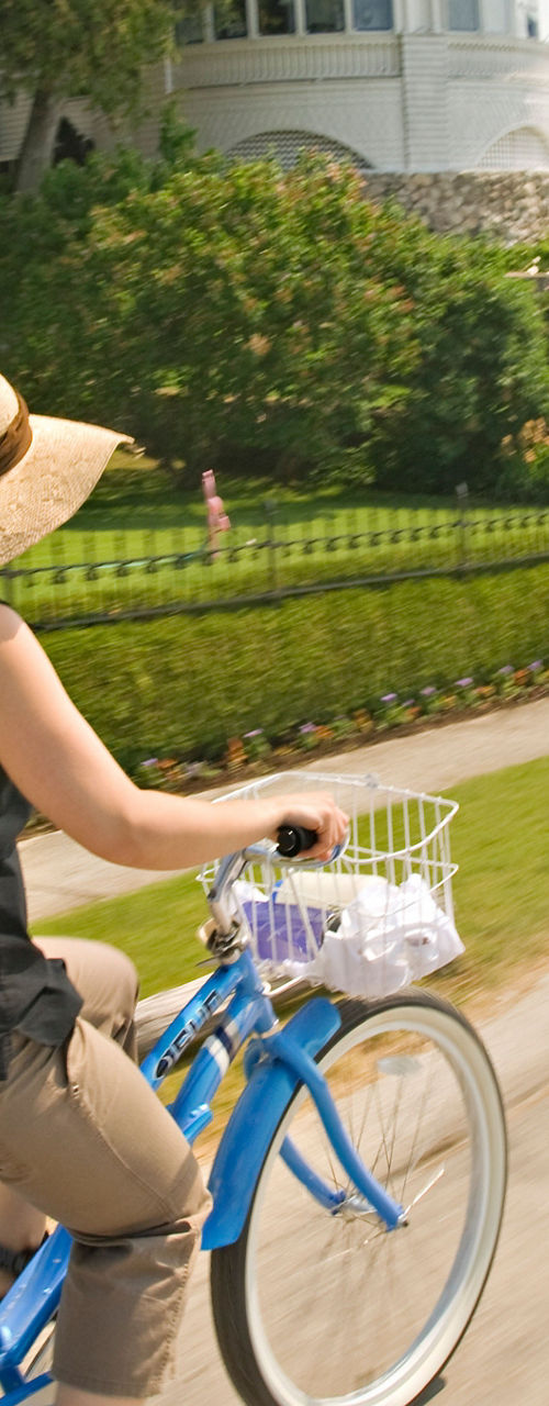 Woman cycling near elegant estate