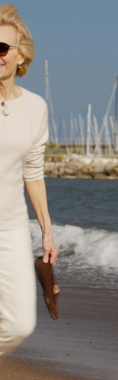 Woman walking on a sunny beach