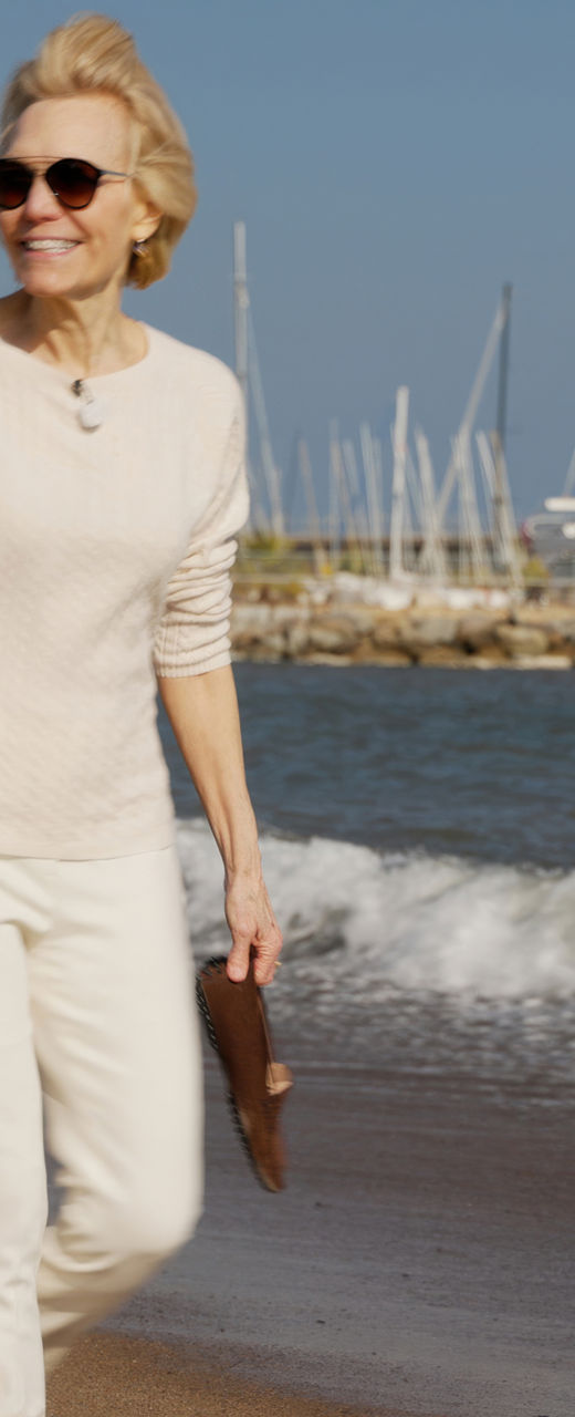 Woman walking on a sunny beach