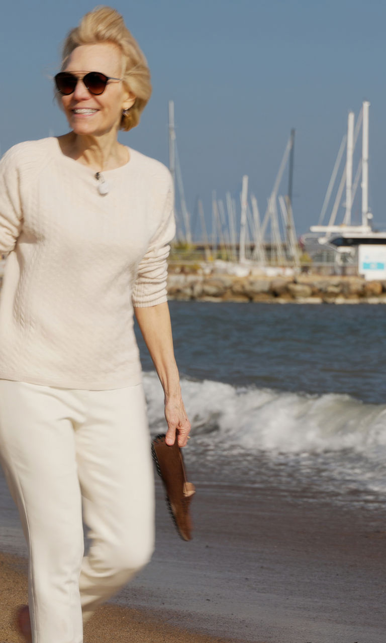Woman walking on a sunny beach