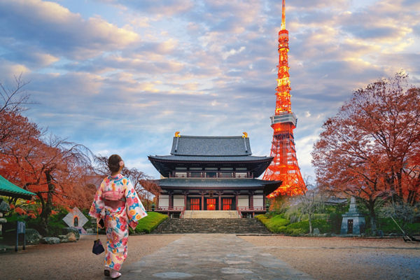 Woman in kimono near Tokyo Tower at sunset