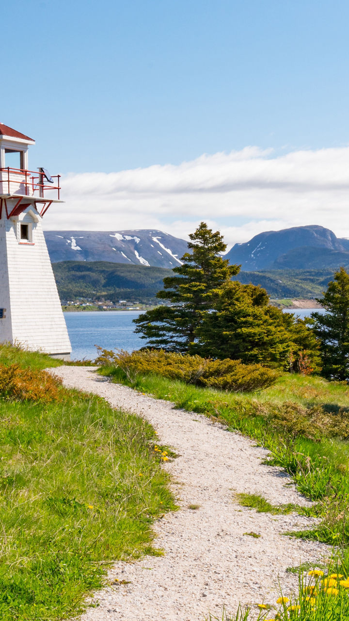 Scenic lighthouse with mountain backdrop