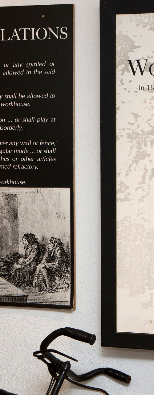 Historical workhouse exhibit with bicycle display
