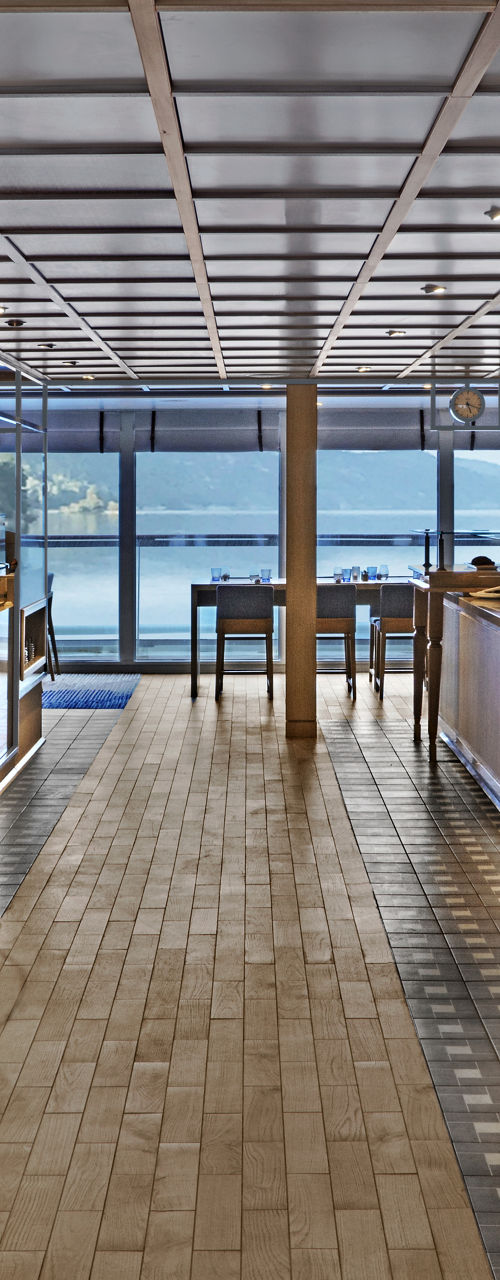 Modern waterfront restaurant interior with seating