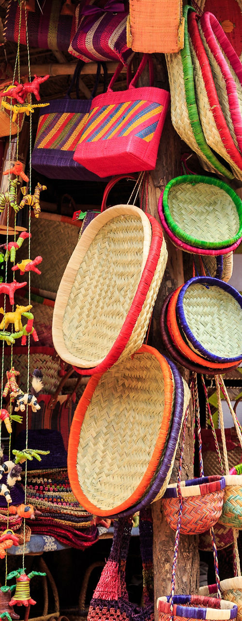 Colorful handmade baskets and hats on display