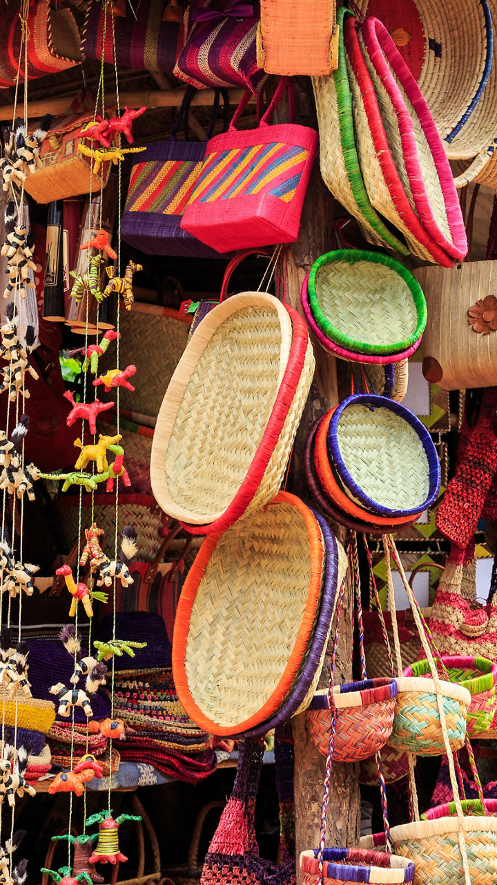 Colorful handmade baskets and hats on display