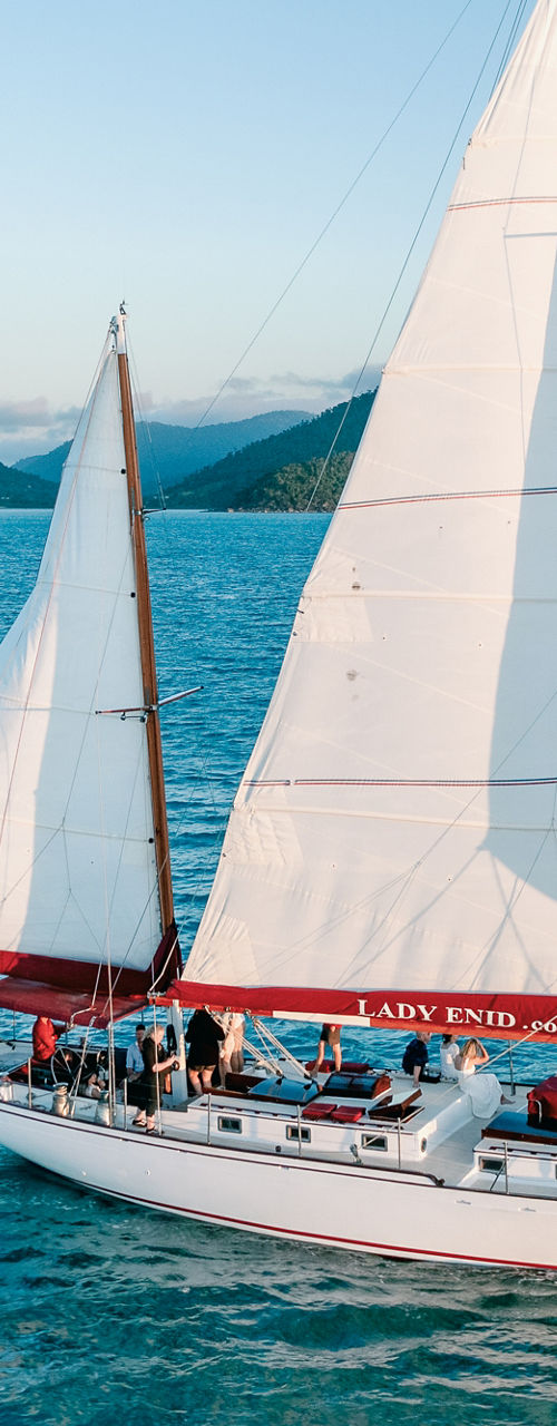 White sailing yacht cruising on blue sea