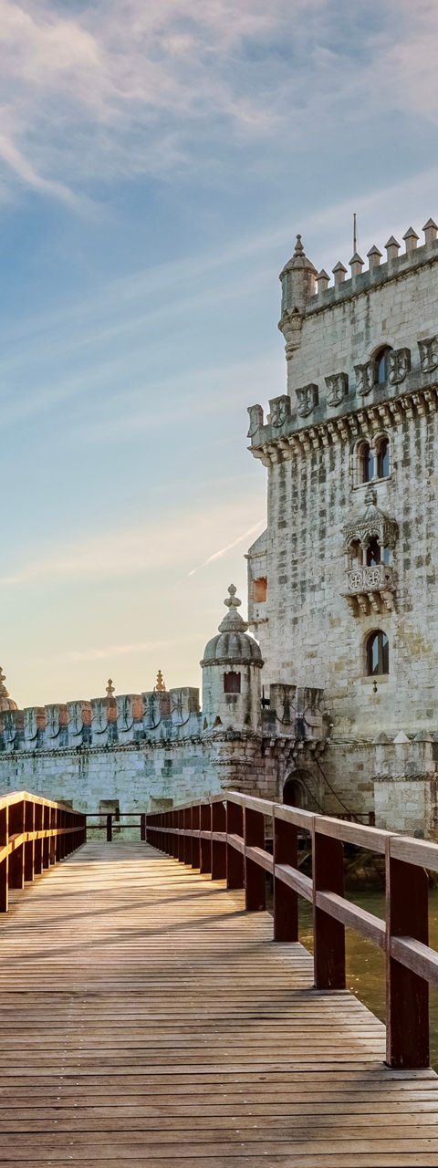Belem Tower at sunset with wooden walkway