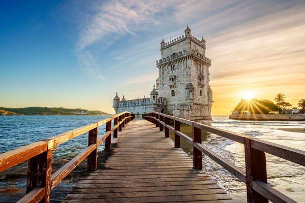 Belem Tower at sunset with wooden walkway