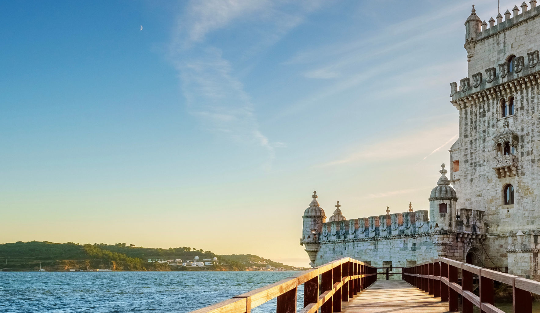 Belem Tower at sunset with wooden walkway