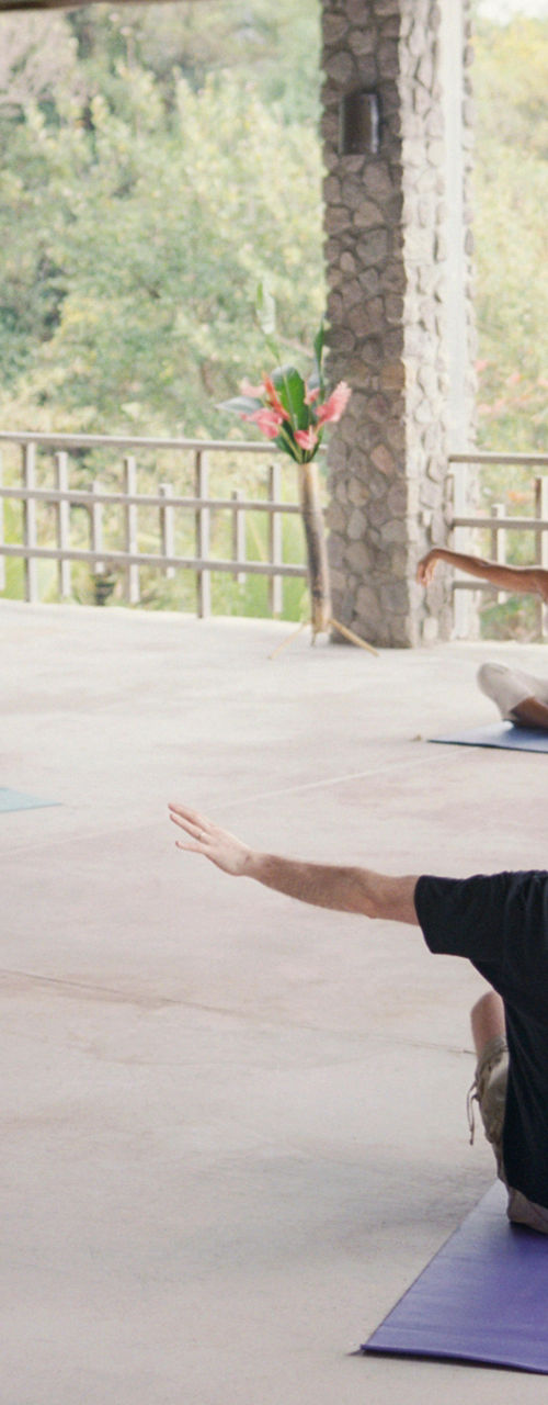 Group yoga session in open pavilion