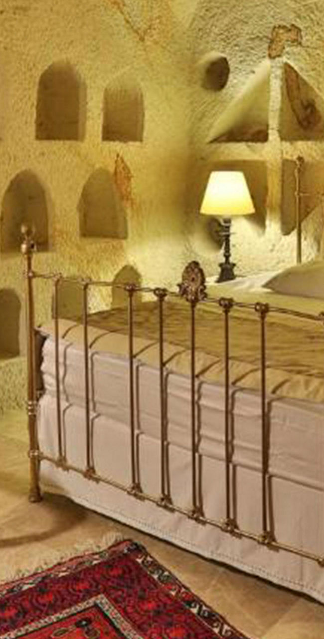 Rustic cave-style bedroom with warm lighting